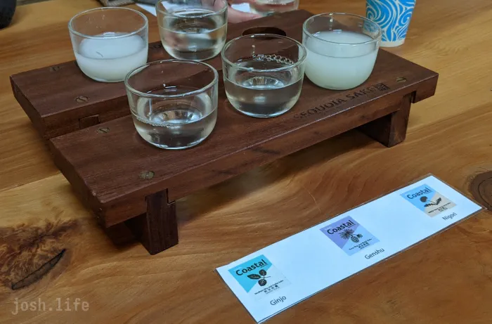 A flight of sake showing a ginjo, genshu, and nigori.